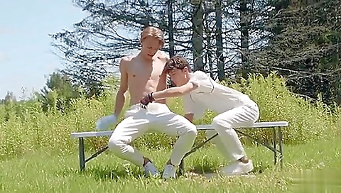 Two players on the grass and riding the other players on the grass