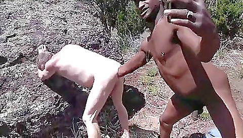 Outdoor black and white women in a white dress fisting